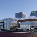 Modern Shopping Mall Architecture With Glass Curtain Wall Grid Roof And High Rise Background