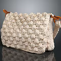 Cream Colored Crocheted Handbag With Textured Surface And Brown Leather Handles