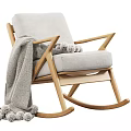 Cozy Wooden Rocking Chair With Light Gray Cushion And Pom Pom Blanket