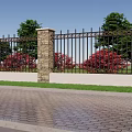 Building Exterior Wall With Black Iron Fence Stone Pillar Green Trees And Red Flower Bushes