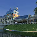 Unique Boutique Guesthouse Building with Blue Roof Yellow Facade Tower Arched Windows Lush Green Lawn