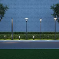 Outdoor Street Lights Arranged Along Road With Grass Trees And Wall