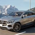Silver Mercedes Coupe SUV Parked On Road With Scenic Mountain View