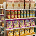 Well Organized Retail Display Shelves With Multi tiered Racks Holding Packaged Cereals Canned Goods And Boxed Products