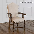 Beige Fabric Upholstered Chair Featuring Dark Wooden Arms Rivet Decorations On White Wall Wooden Floor