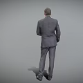 A Man In Professional Gray Suit Standing With Hands In Pockets On Gray Background