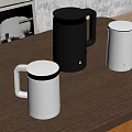 Three Modern Black And White Kettles Placed On Wooden Table With Stylish Design