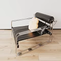 Modern Black Single Chair With Stainless Steel Frame And Yellow Cushion In Minimalist Setting
