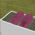 Two Black Cars Parked on Grid Pattern Parking Lot With Green Grass Background
