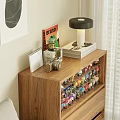 Decorative Figurine Set On Wooden Cabinet With Table Lamp Books And Small Plant