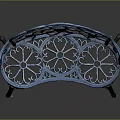 Blue Metal Garden Bench With Ornate Floral Cutout Patterns And Curved Frame