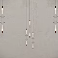 Multiple Modern Glass Chandeliers Hanging From Ceiling With Warm Light And Minimalist Design