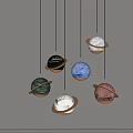 Modern Multicolored Planet Pendant Lights With Rings Hanging Against Gray Wall