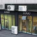 Garden Ornaments Displayed Outside Building With Glass Windows And Air Conditioners