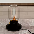 Table Lamp With Glass Shade Black Base Yellow Knob And Orange Bulb On Marble Countertop