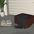 Brown Upholstered Stool With Gray Blanket Open Book Plant And Lattice Screen On Gray Floor