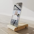 Modern Iron Phone Stand Holding Mobile Phone With Screen Showing Woman And Building Interior