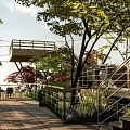 Park Landscape With Wooden Viewing Platform Surrounding Trees Red Leaves Stone Wall And Tables Chairs