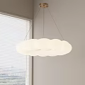 Soft Cloud Shaped Pendant Light Hanging In Interior With Window Blinds And Light Colored Walls