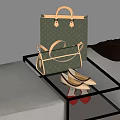 Green Handbag On Clear Tray With Gold Shoes And Brown Scarf By Light Gray Sofa