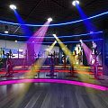 Modern Fitness Studio With Spin Bikes Neon Lights And Large Screen