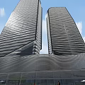Modern Office Building Featuring Glass Facade Horizontal Lines And Green Surroundings
