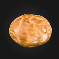 Freshly Baked Round Bread With Golden Brown Crust And Cracked Surface On Black Background