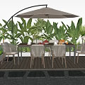 Outdoor Table with Umbrella and Chairs Surrounded by Green Plants on Wooden Deck