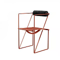 Modern Single Chair Featuring Red Metal Frame And Black Cushioned Backrest Design