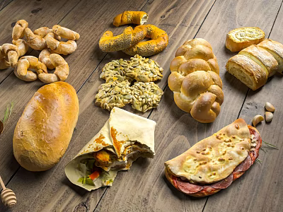 Assorted Fresh Baked Bread and Savory Food Items Displayed on Rustic Wooden Table 3d model