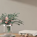 Transparent Glass Vase With Pink Roses And Eucalyptus Leaves On Light Gray Wall