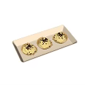 Three Golden Shell Tarts With White Cream And Black Sprinkles On White Rectangular Tray 3d model