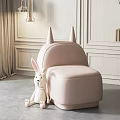 Pink Single Sofa With Small Pointed Horns White Rabbit Plush Toy Light Walls Brown Curtains