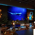 TOMO Friends Festival Bar Interior with Neon Lights Whale Screen Live Music and Dining Tables
