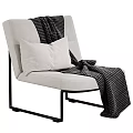 Light Beige Accent Chair with White Pillow Black White Checkered Blanket on Black Metal Frame