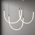 Modern Curved Chandelier With White Tubes And Golden Details Hanging In Minimalist Setting
