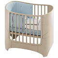 Modern Wooden Baby Crib With Curved Frame Vertical Rails And Blue Dotted Sheets
