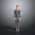 Man Wearing Gray Long Sleeve Top and Pants Standing in Studio with Gray Background
