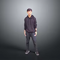 Child Standing In Dark Hoodie And Dark Pants Against Grey Background