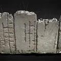 Broken Stone Wall Structure With Cracks Fence Like Lines And Green Plants At Base