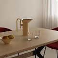 Glass Cups on Light Wooden Table with Kettle Bowl of Pears Red Chairs White Curtains