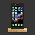 Red Mobile Phone Placed on Wooden Stand with Screen Showing Multiple App Icons