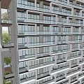 Modern High Rise Residential Building With Large Windows Balconies And Greenery