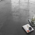 Modern Gray Textured Floor Tiles In Living Interior Space With Magazine Glass Vase And Tray