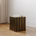 Modern Golden Side Table With Vertical Slats And Stack Of Books On Wooden Floor