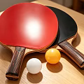 Red And Black Table Tennis Rackets With Wooden Handles And White Yellow Balls On Table