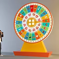 Person Taking Photo of Lucky Draw Wheel With Colorful Icons and Yellow Base