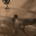 Elegant Dining Table Set With Glass Top Carved Legs And Small Plant