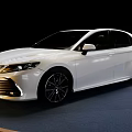 White Toyota Camry Sedan on Blue Display Stand with Black Background