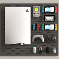 Organized Gaming Gear with White PlayStation Console Game Boy Switch Controllers Mice on Gray Pegboard